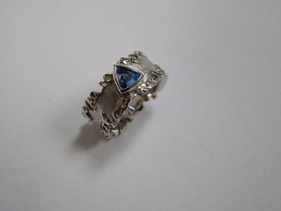 Blue Triangular Sapphire in Wavy Sterling Silver Band Image