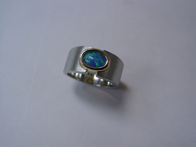 Oval Blue Opal in Yellow Gold Bezel Mounted in White Gold Ring Image